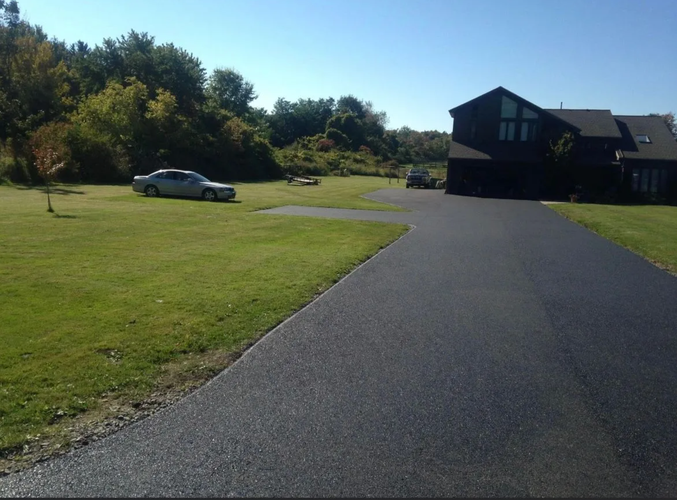 Long asphalt driveway rural property Rochester NY