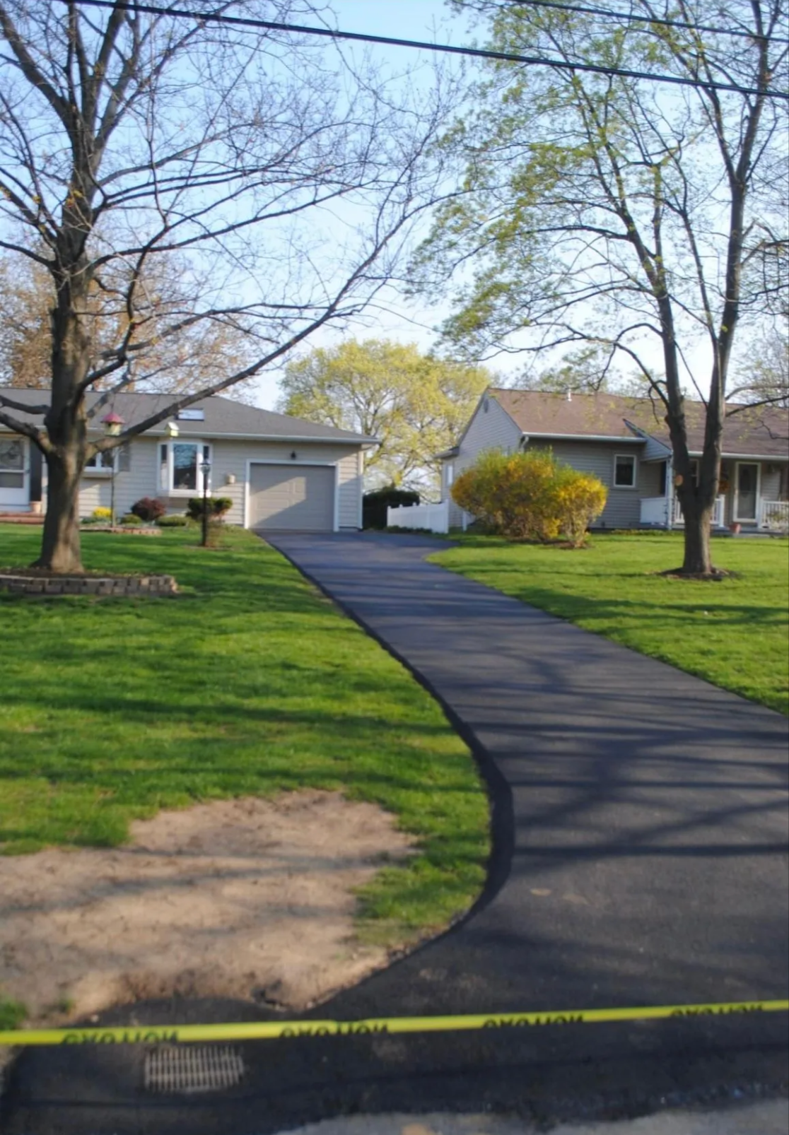 Curved asphalt driveway with landscaping Rochester NY